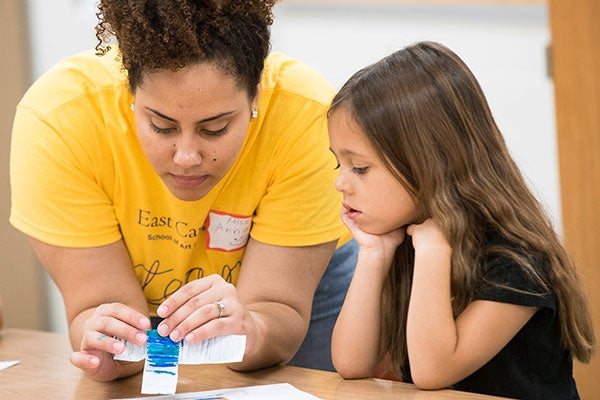 A student aids a child.